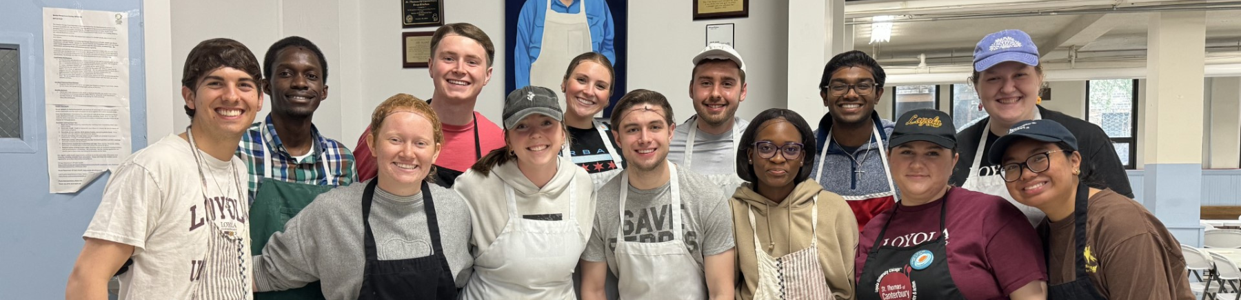 A group of soup kitchen volunteers smiling at the camera. Photo Credit: Hanako Maki